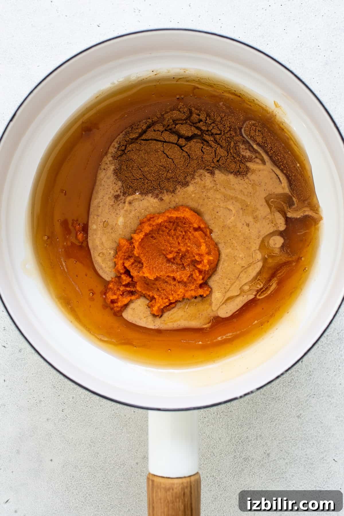 A frying pan filled with a mixture of brown and orange.