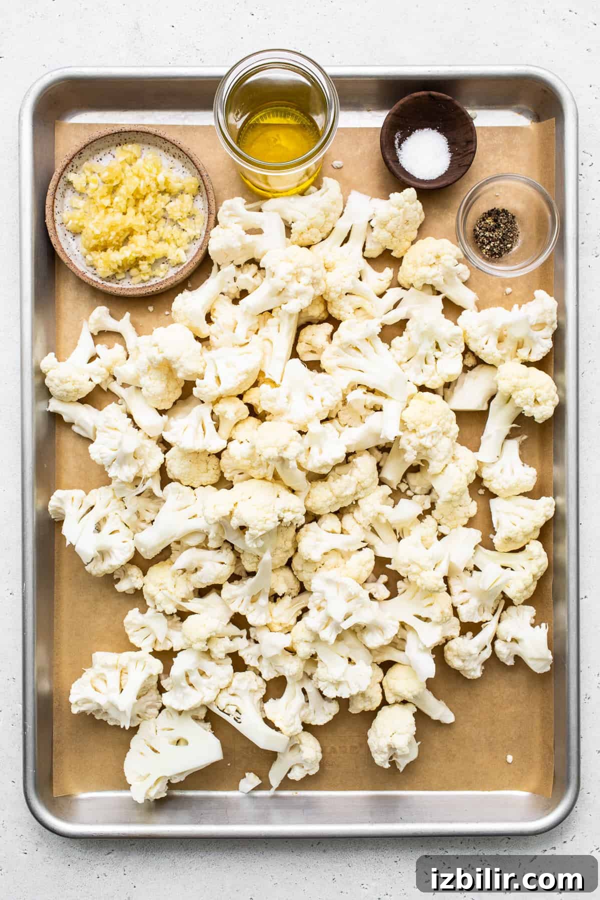 Cauliflower florets on a baking sheet.