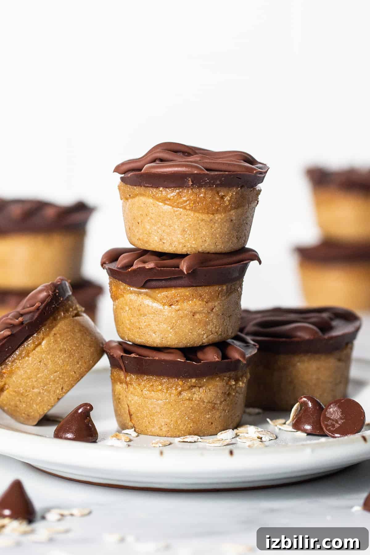 No-Bake Peanut Butter Twix Cups Recipe 7 A stack of chocolate peanut butter cups on a plate.