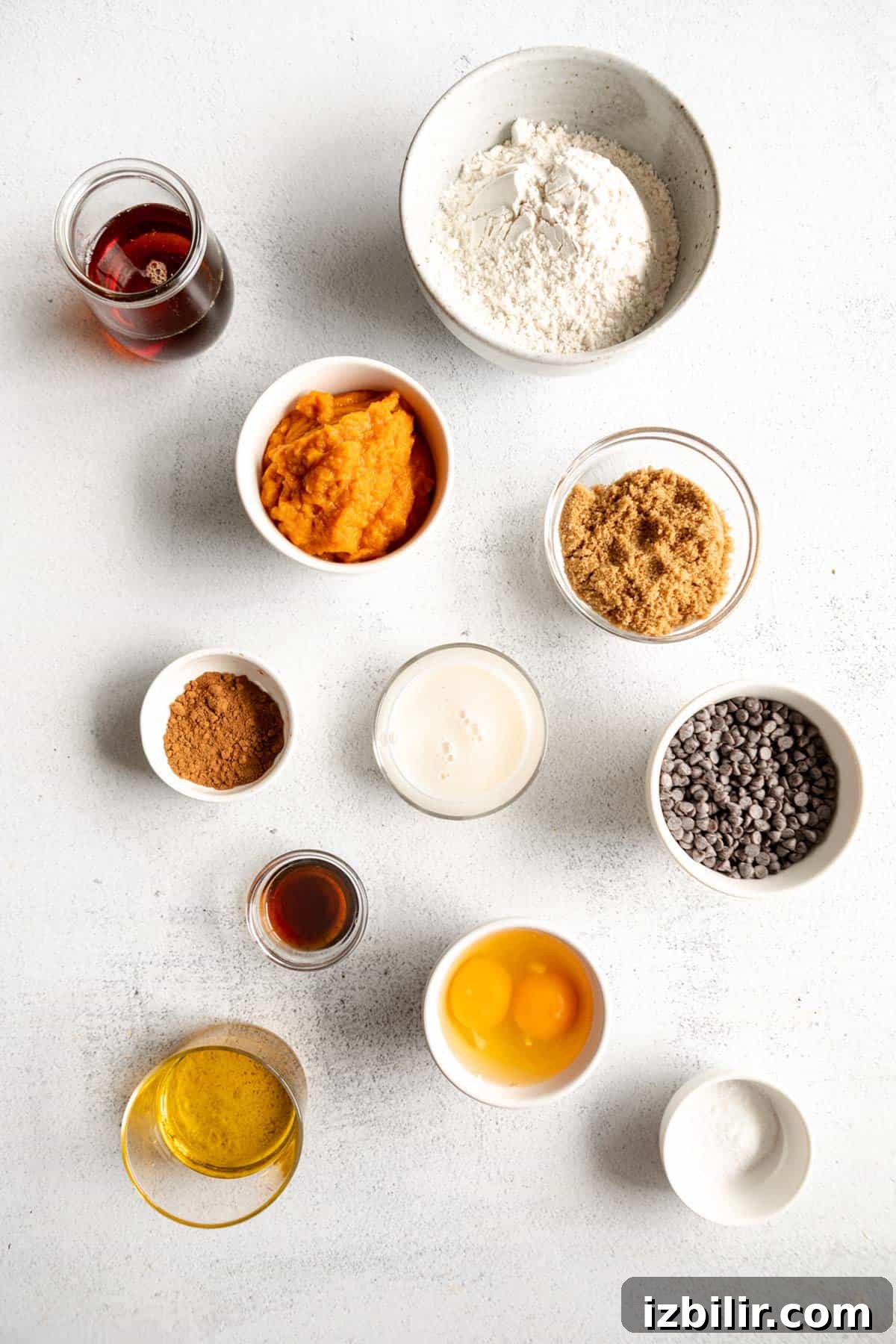 Classic Pumpkin Muffins Recipe with Warm Fall Spices 3 Ingredients for a pumpkin pie in bowls on a white surface.