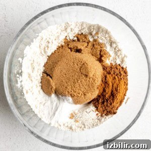 Classic Pumpkin Muffins Recipe with Warm Fall Spices 5 A glass bowl with cinnamon, sugar and flour in it.