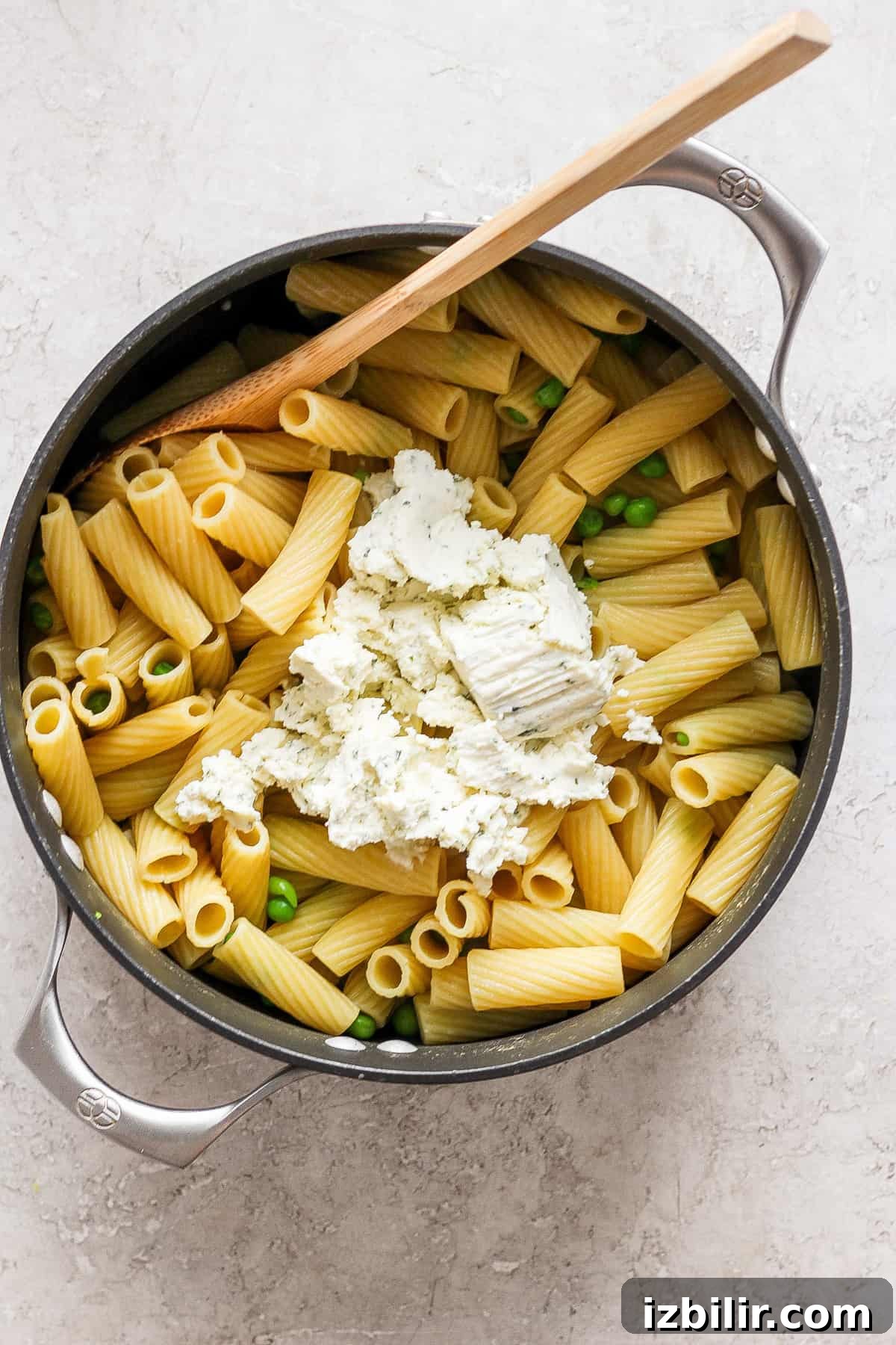 Creamy One-Pot Boursin Pasta Recipe 6 Penne pasta with peas and feta cheese in a skillet.
