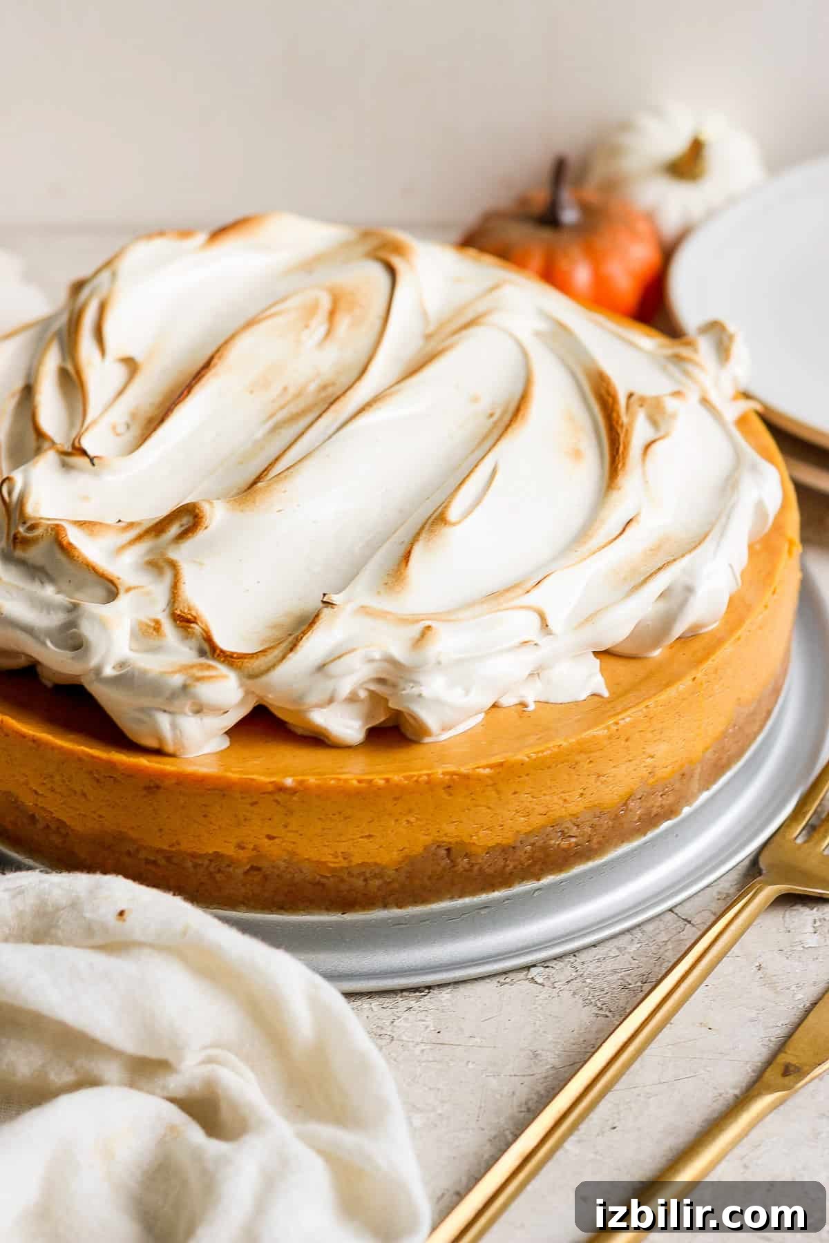 A pumpkin cheesecake with meringue on top.