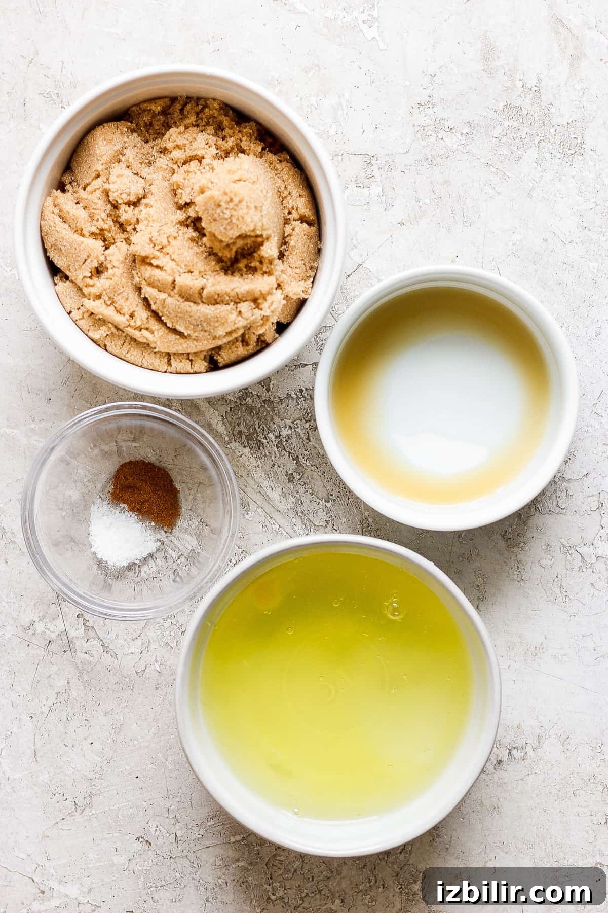How to Make Brown Sugar Swiss Meringue 3 A bowl of peanut butter, olive oil, and salt on a white surface.