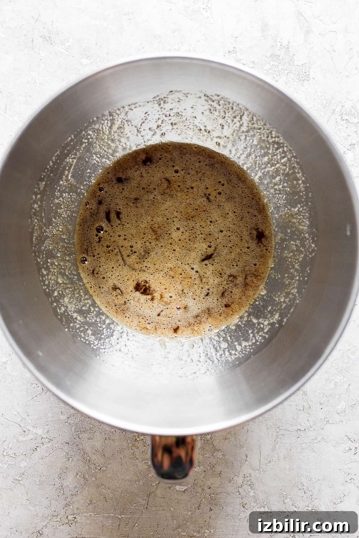 How to Make Brown Sugar Swiss Meringue 4 A metal pan with brown liquid in it.