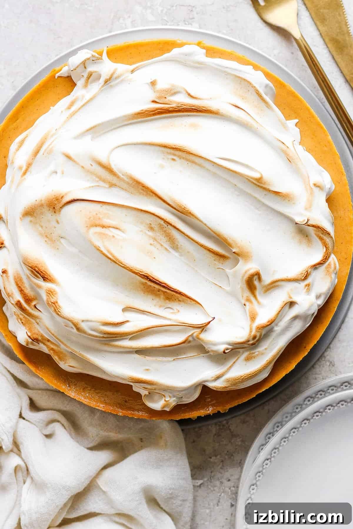 How to Make Brown Sugar Swiss Meringue 6 A pie with meringue topping on a plate.