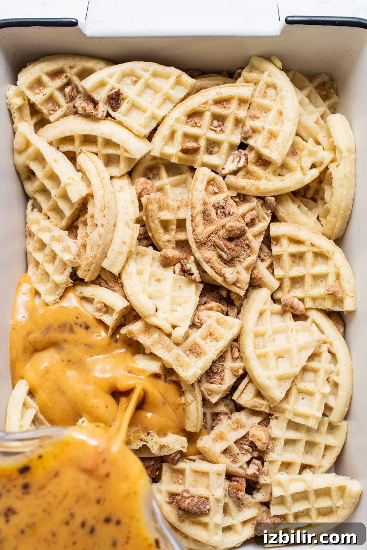 Waffles in a white baking dish with sauce.