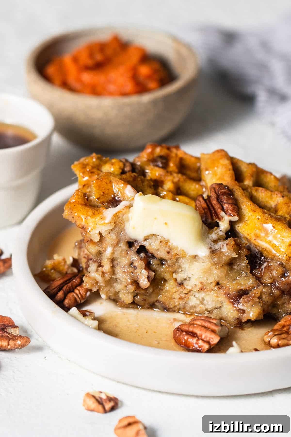 A plate with waffles and pecans on it.
