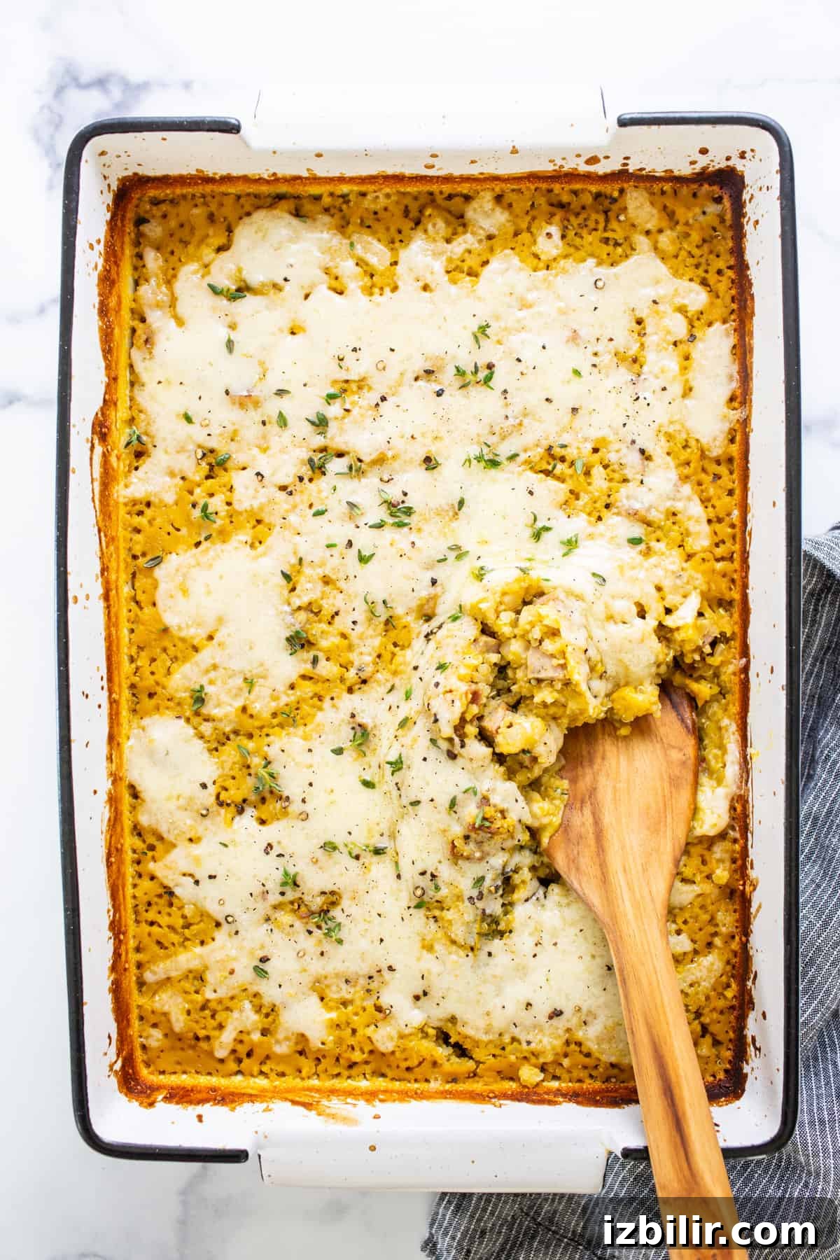 A casserole dish with a wooden spoon in it.