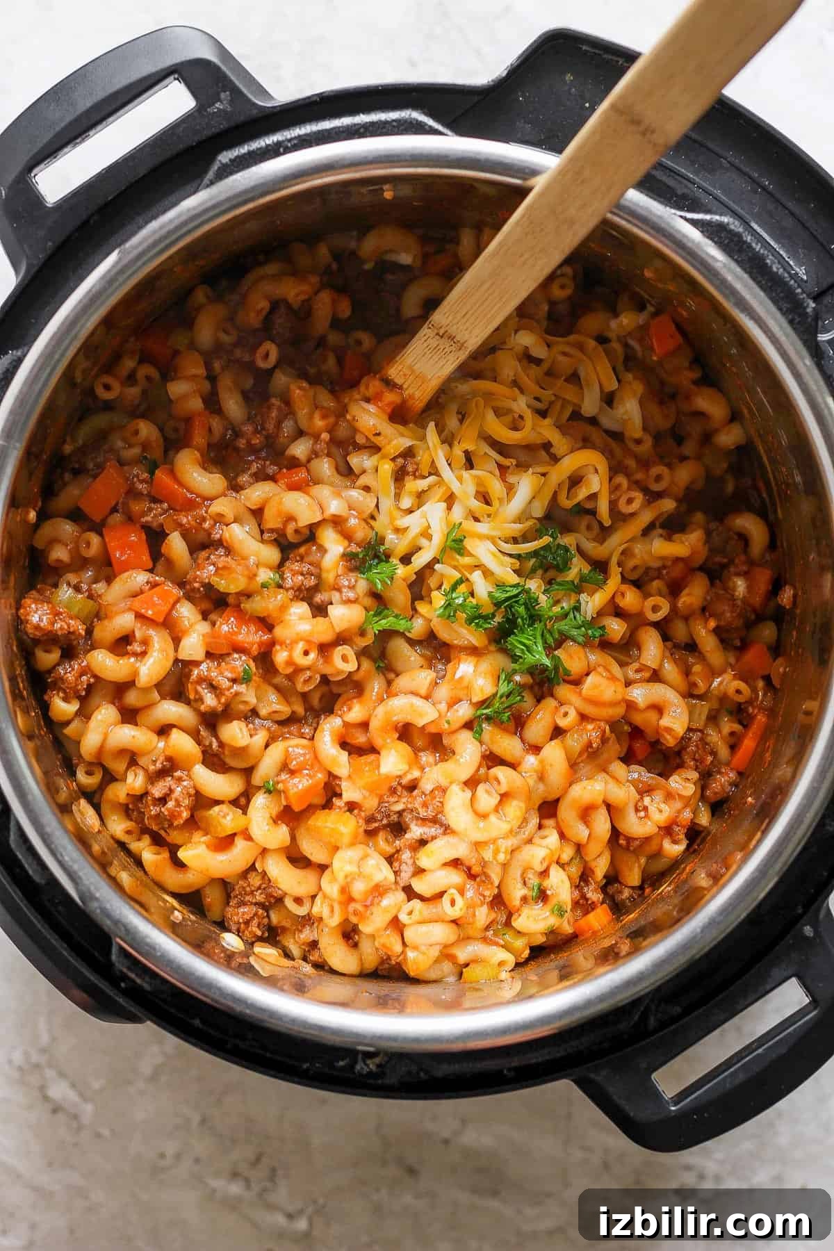 Instant Pot filled with pasta and seasoned ground beef, ready to serve.