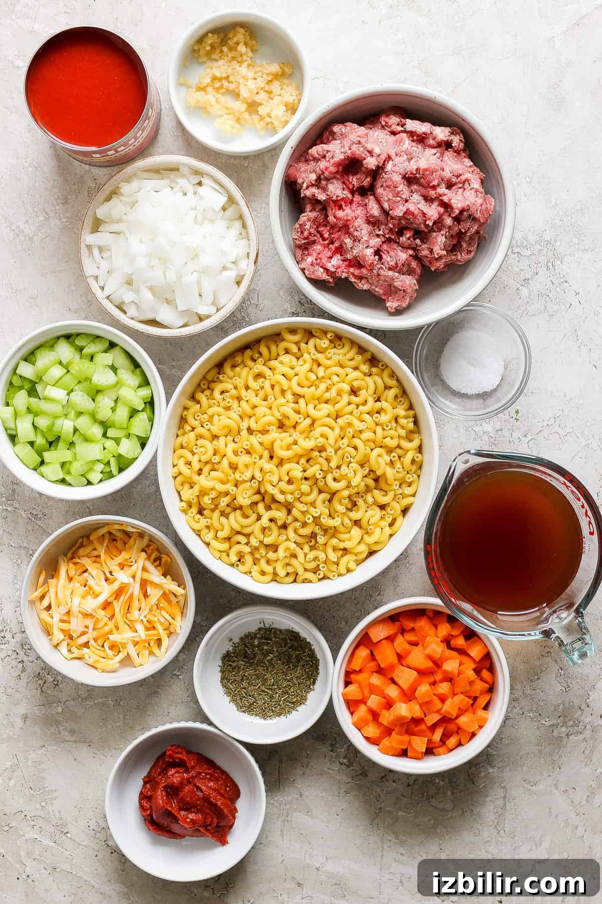 Bowls of prepared ingredients for Instant Pot hamburger helper laid out on a countertop.