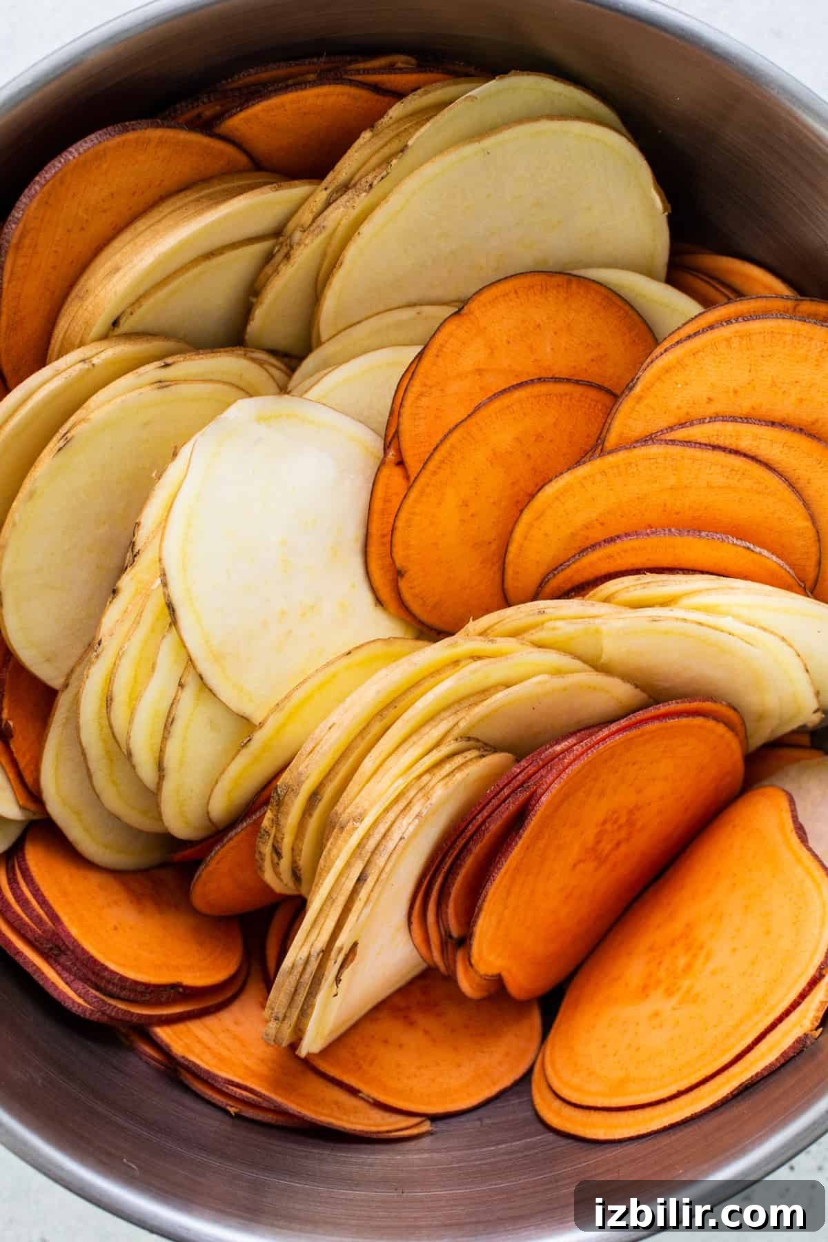Classic Sweet Potato Au Gratin Recipe 5 A bowl full of sweet potato slices.