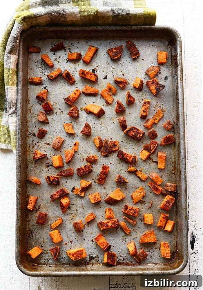 Roasted sweet potatoes are the most delicious vegetable addition to any meal. In this post, we're teaching you how to roast sweet potatoes perfectly every time. sweet potato cubes on pan