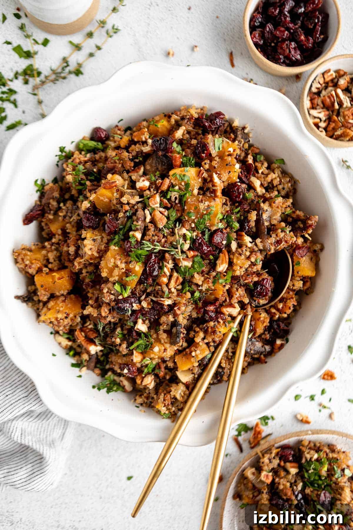 Roasted Butternut Squash and Quinoa Stuffing 2 Cranberry quinoa salad with cranberries and nuts in a white bowl.