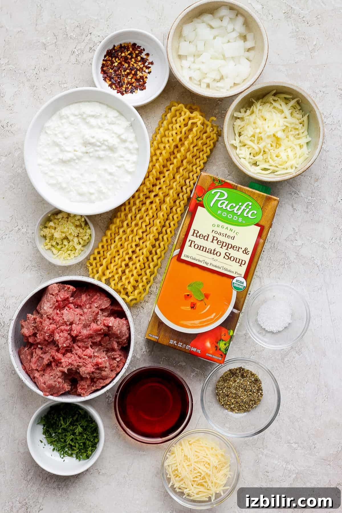 One-Pot Lasagna Pasta Recipe: Creamy Skillet Lasagna 3 The ingredients for a pasta dish are laid out on a table.