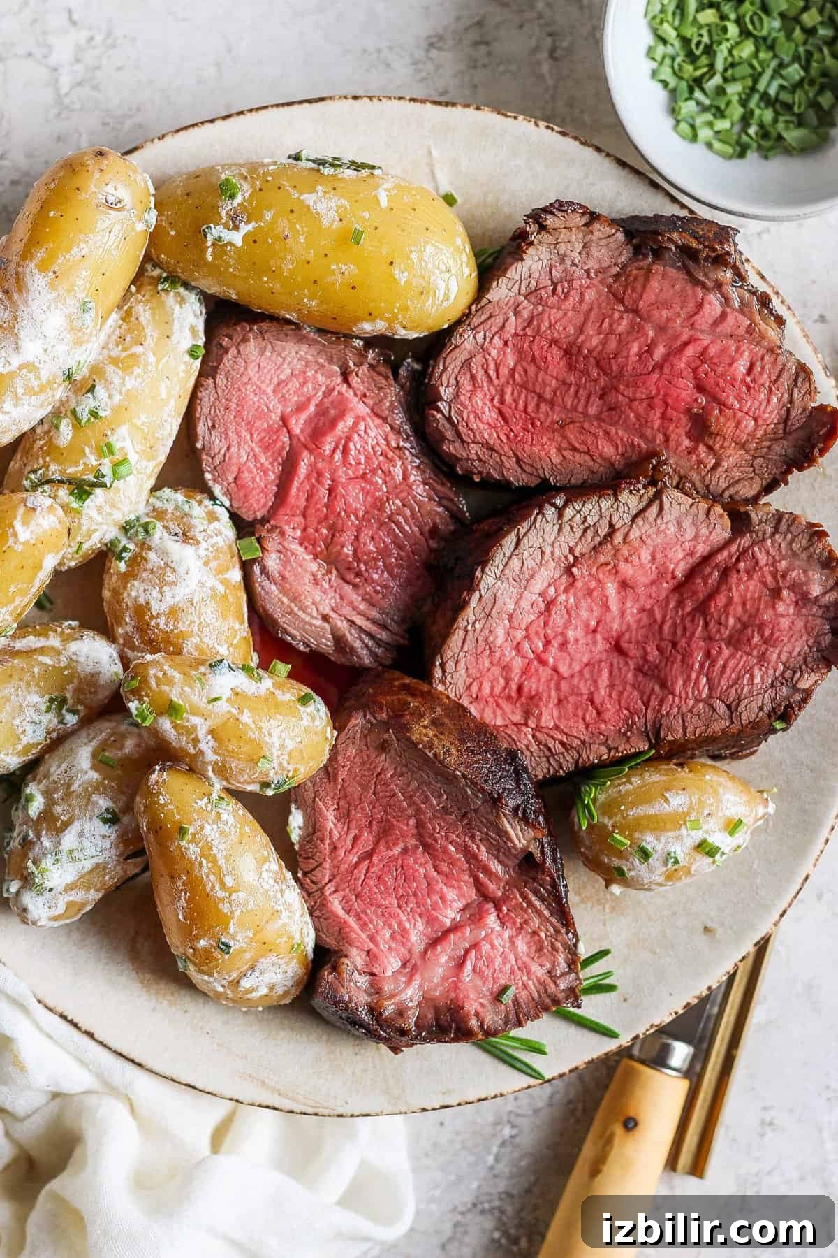 Steak and potatoes on a plate.