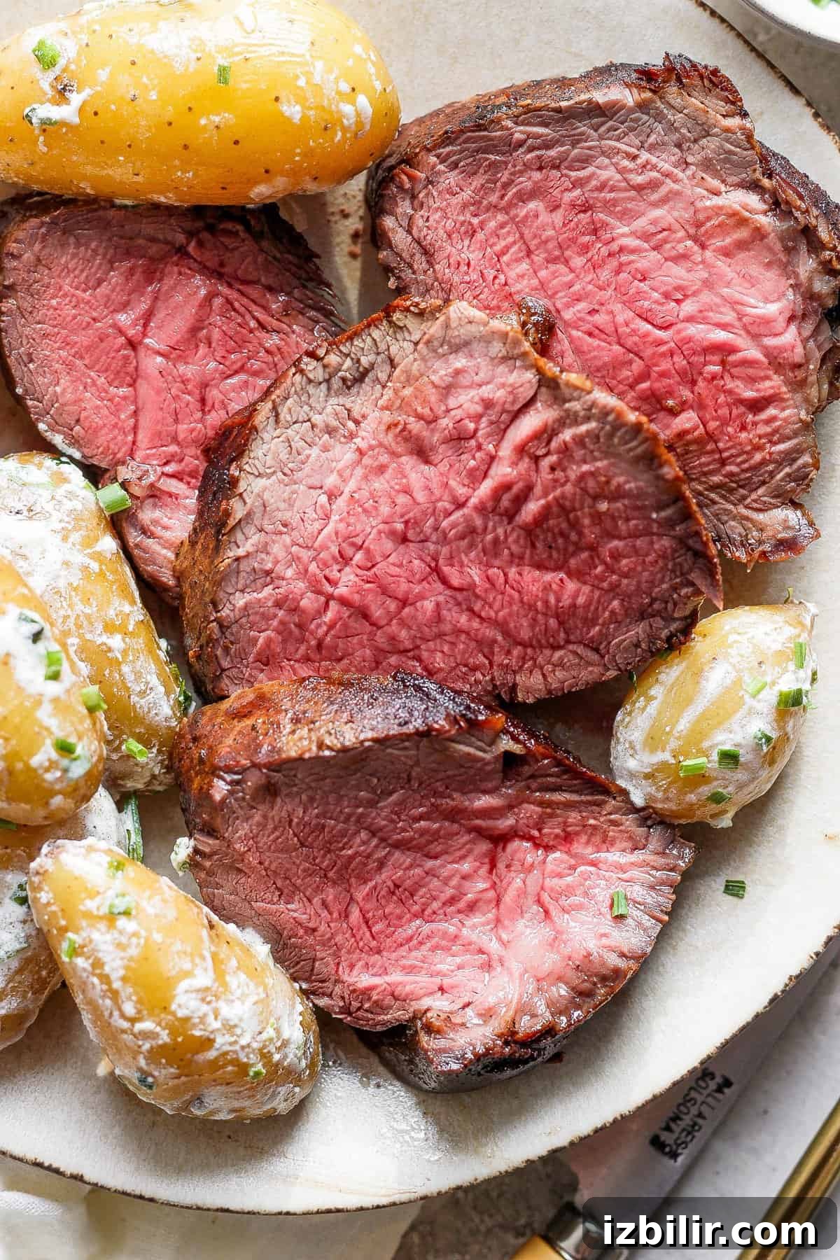 Steak and potatoes on a plate.
