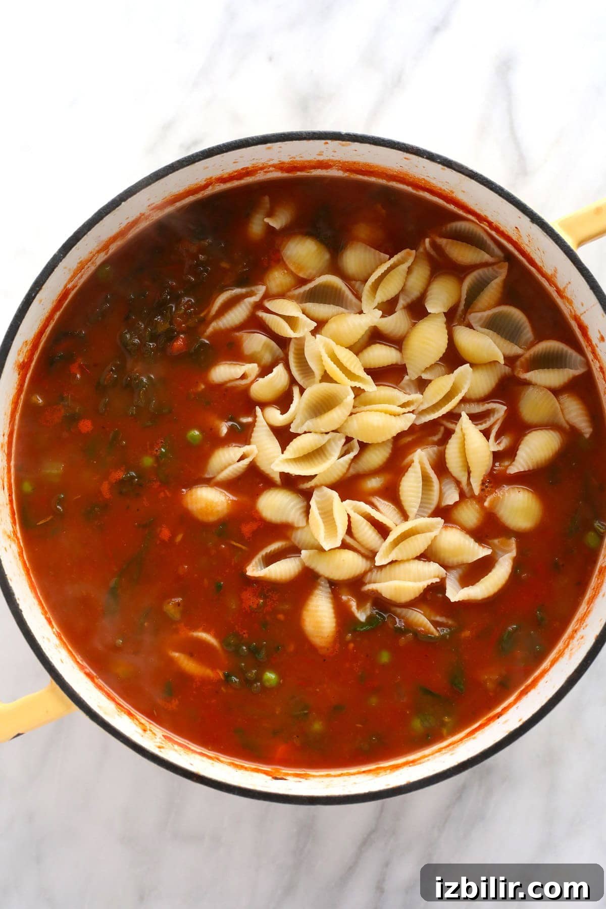 Noodles mixed into minestrone soup.