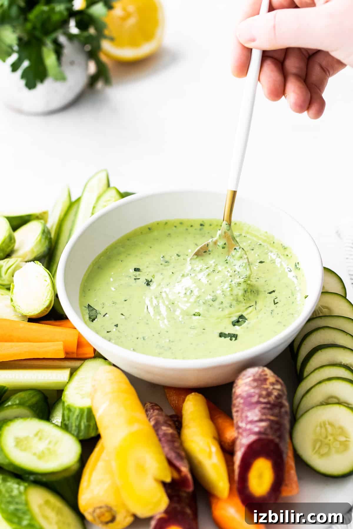 Creamy Green Goddess Dressing Recipe with Fresh Herbs 6 spooning green goddess dressing