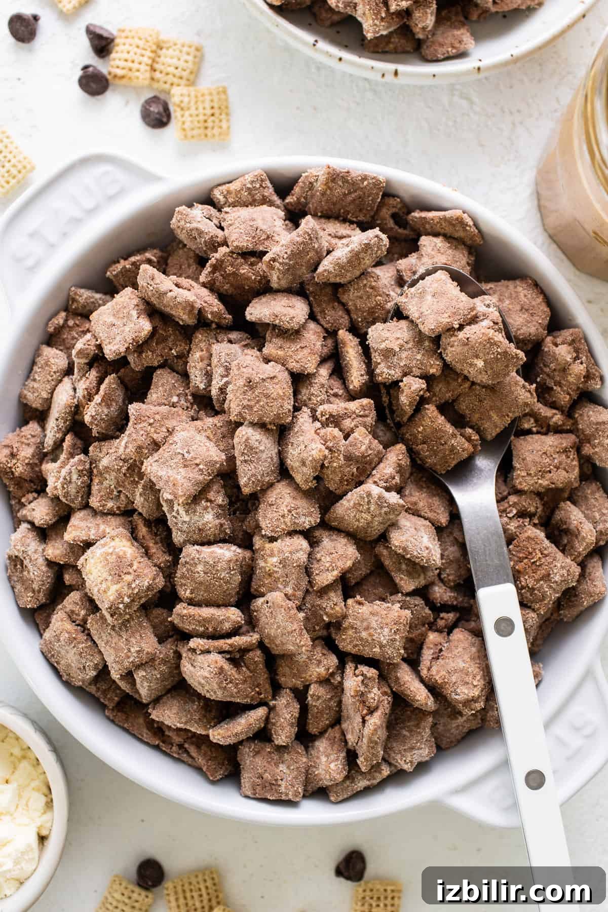 Chocolate peanut butter cheetos in a bowl with a spoon.