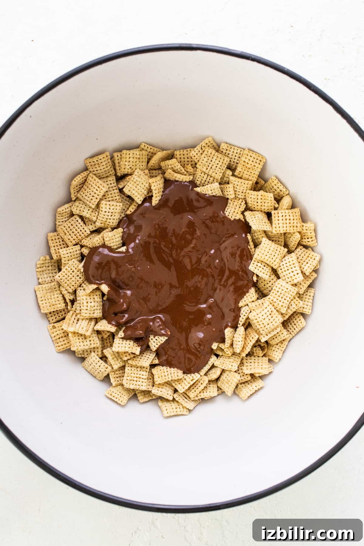 A bowl filled with chocolate and cheetos.
