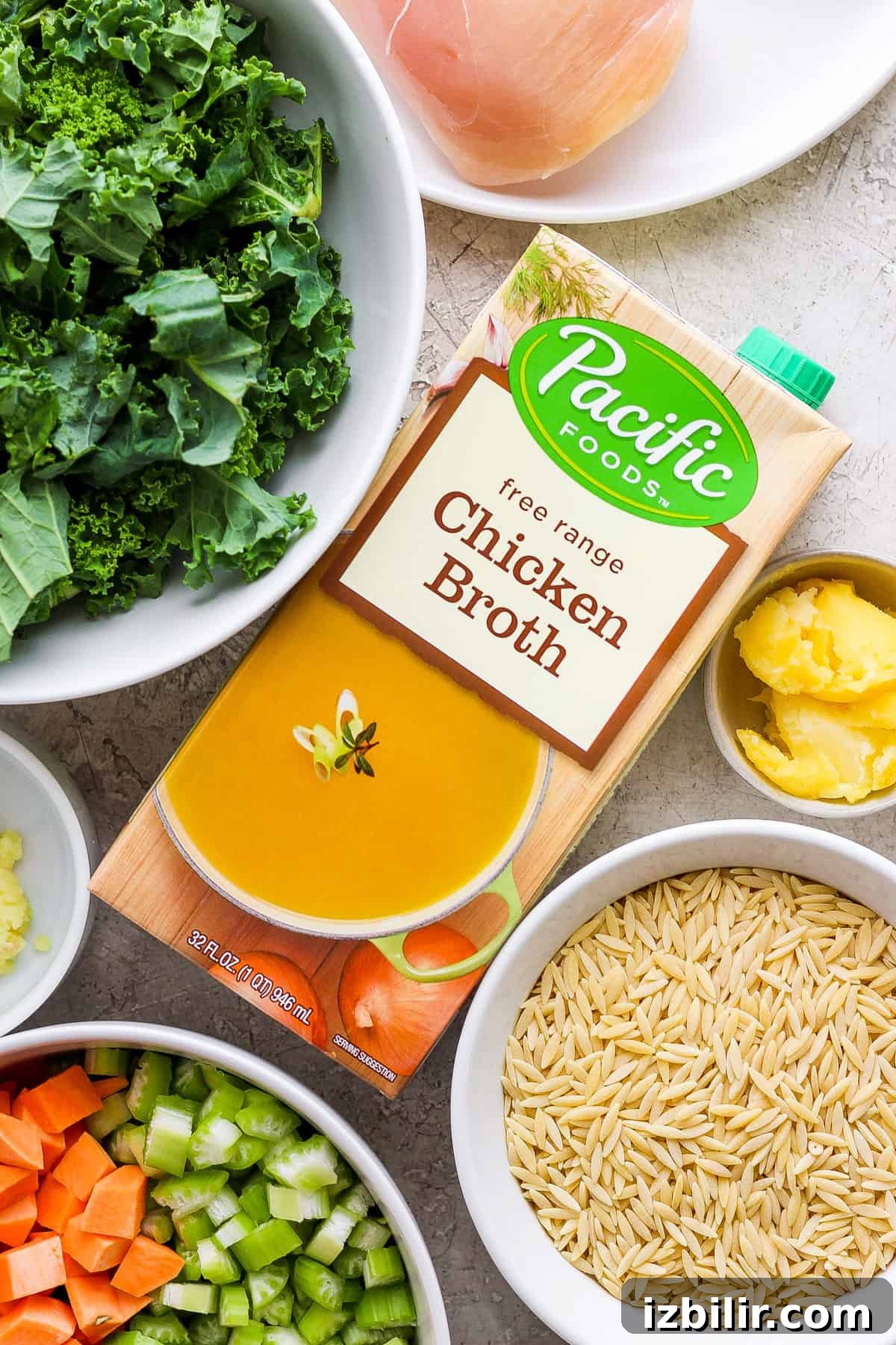 Golden Chicken and Orzo Soup Recipe 3 A bowl of chicken broth and other ingredients on a table.
