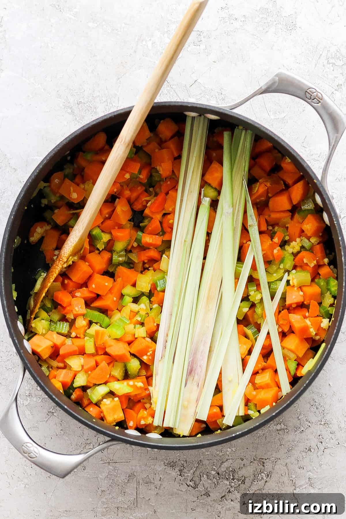 Golden Chicken and Orzo Soup Recipe 4 A pan with carrots and leeks in it.