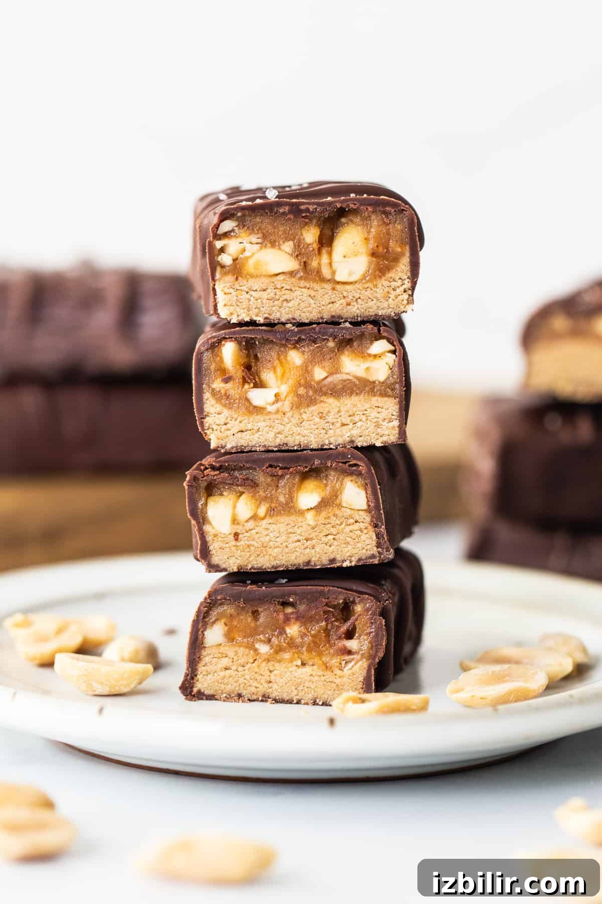 A stack of chocolate peanut butter bars on a plate.