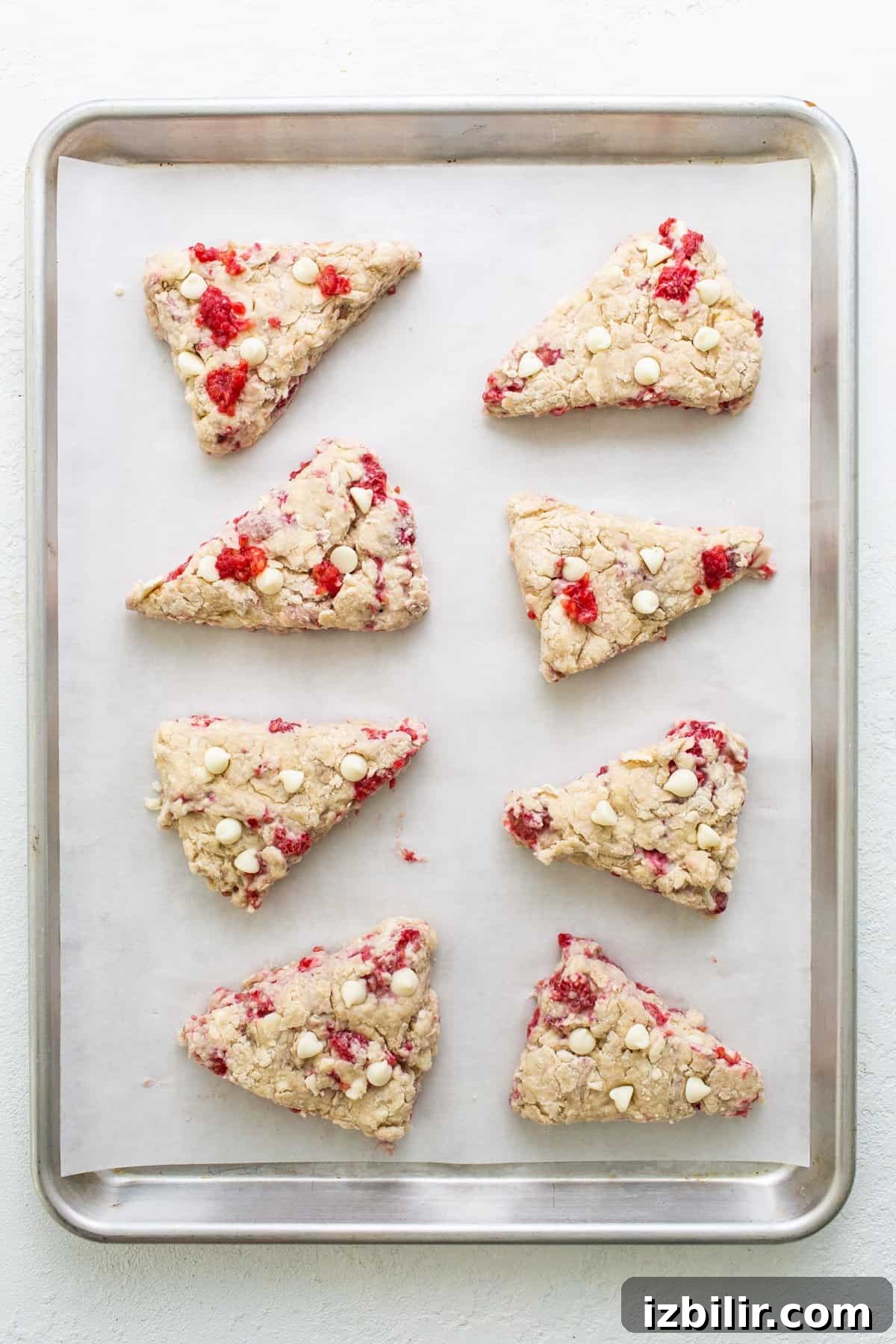 Cranberry almond scones on a baking sheet.