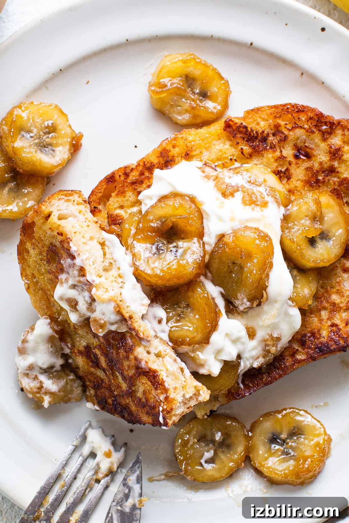 Caramelized Bananas Foster French Toast with Rum Sauce 5 French toast with bananas and whipped cream.