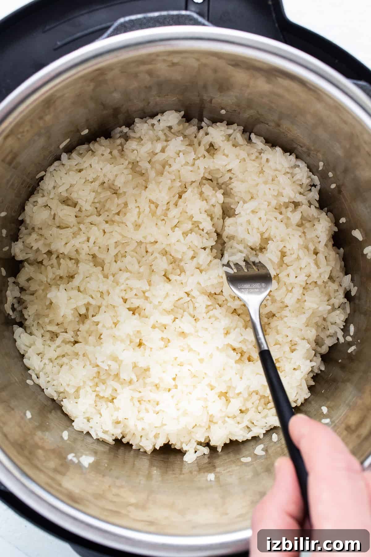 A person pouring rice into an instant pot.