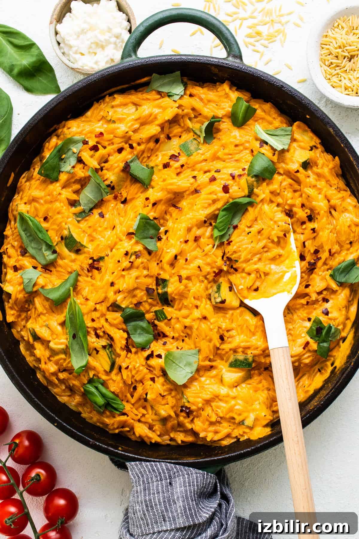 One-Pot Creamy Tomato Orzo with Fresh Basil 5 A skillet filled with mashed potatoes, tomatoes and herbs.