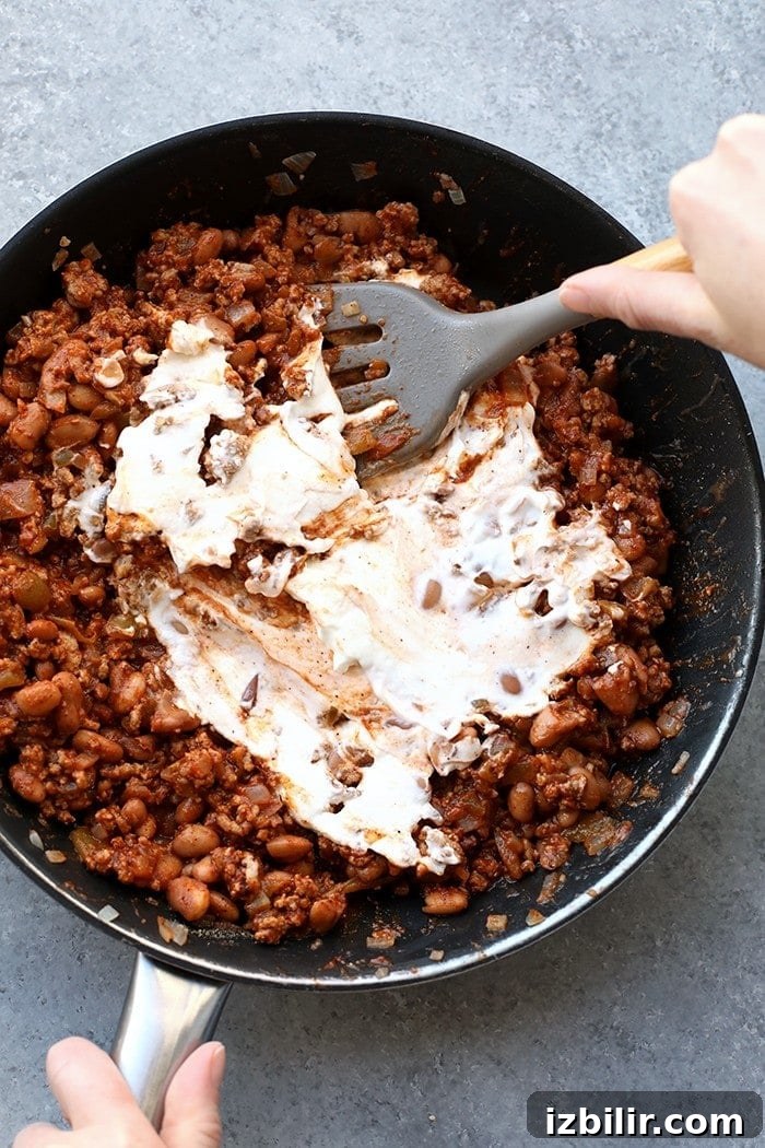 Meat browning in a pan for chili cheese dip meat in pan