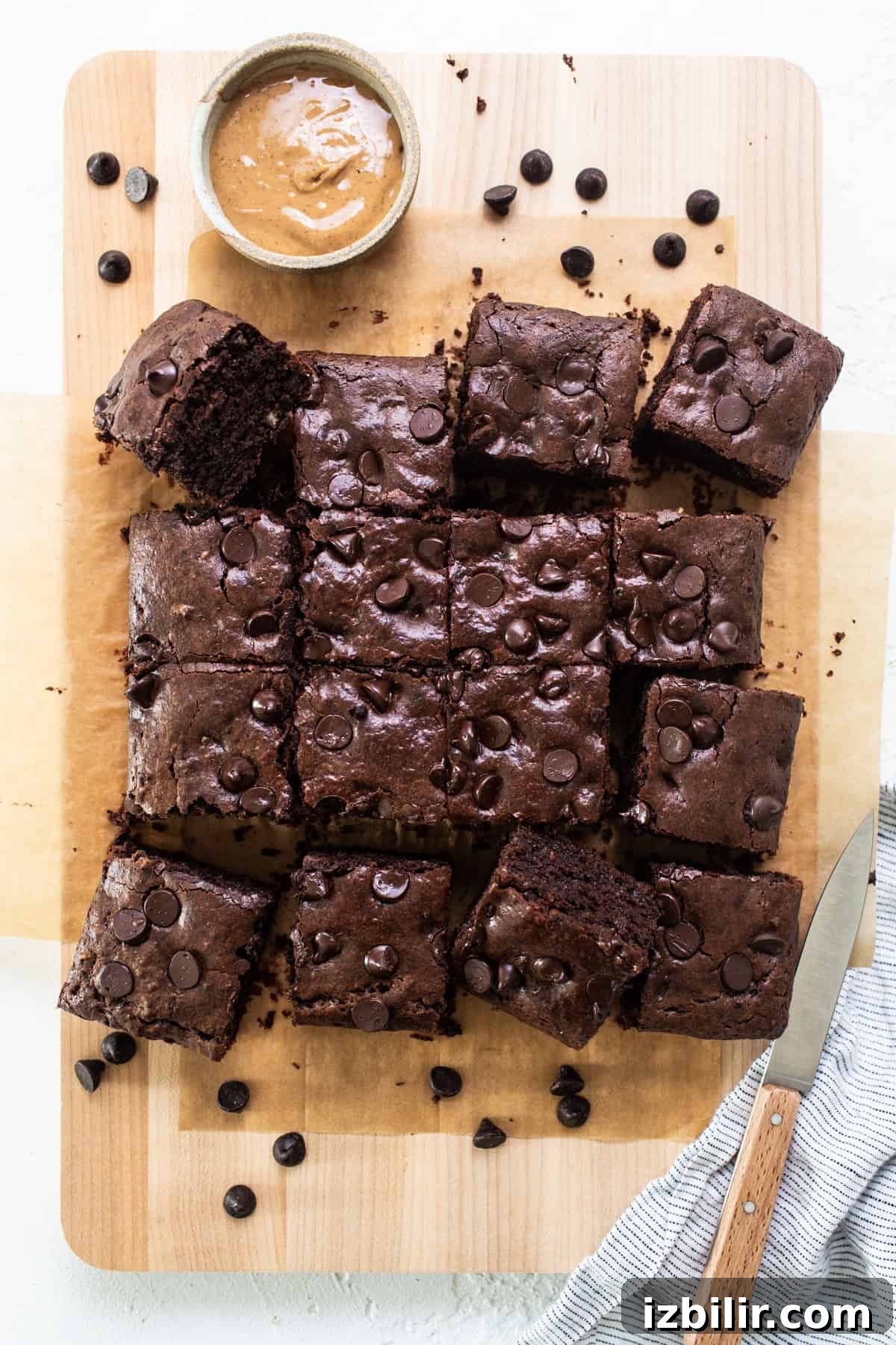 Flourless Peanut Butter Protein Brownies Recipe 2 Chocolate brownies on a cutting board with peanut butter.