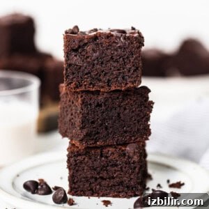 Flourless Peanut Butter Protein Brownies Recipe 7 A stack of chocolate brownies on a plate.