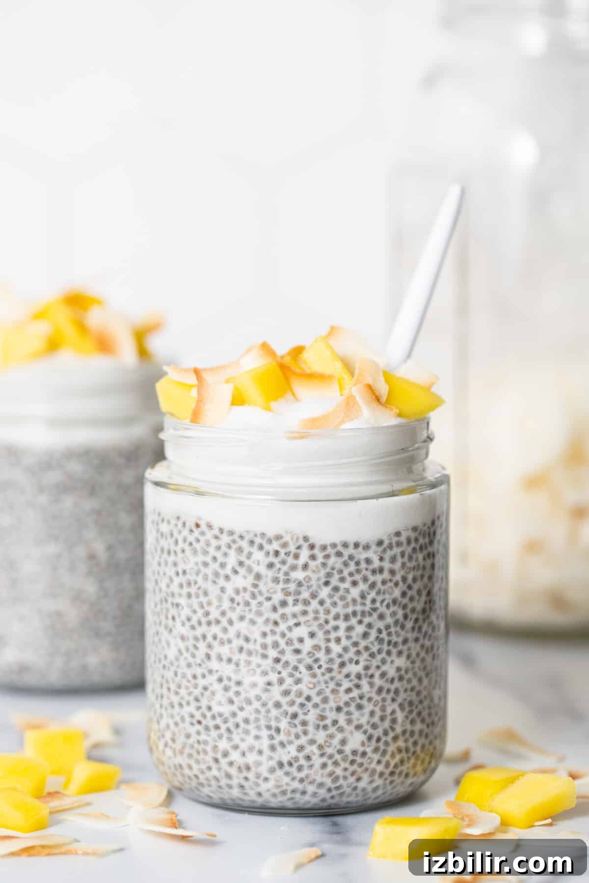 Coconut Cream Pie Chia Pudding Cups with Protein 2 Two jars of chia pudding on a marble counter.