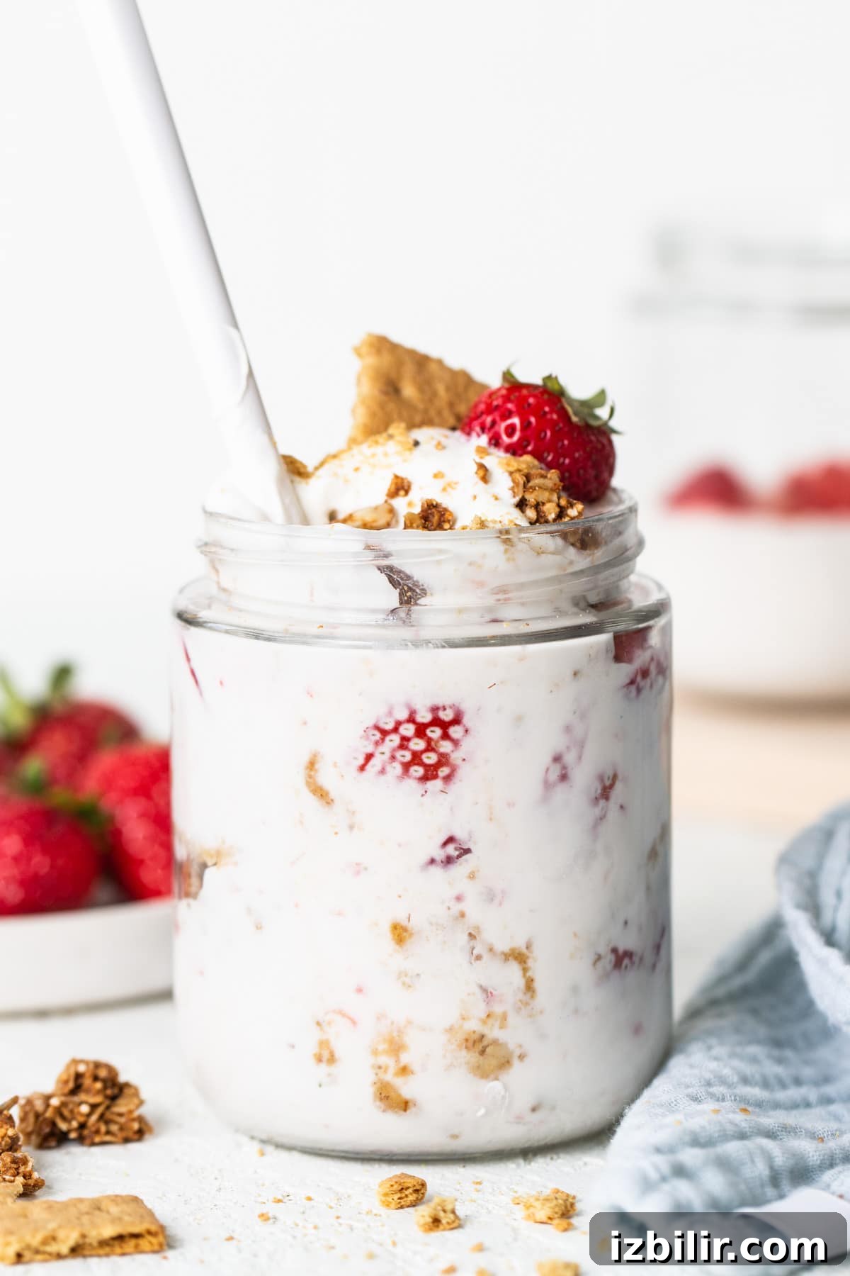 Strawberry Protein Cheesecake Jars with Cottage Cheese 6 A jar of yogurt with strawberries and granola.