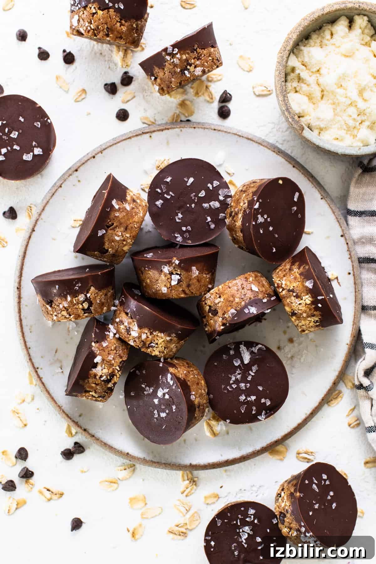 A plate topped with chocolate covered granola bars.