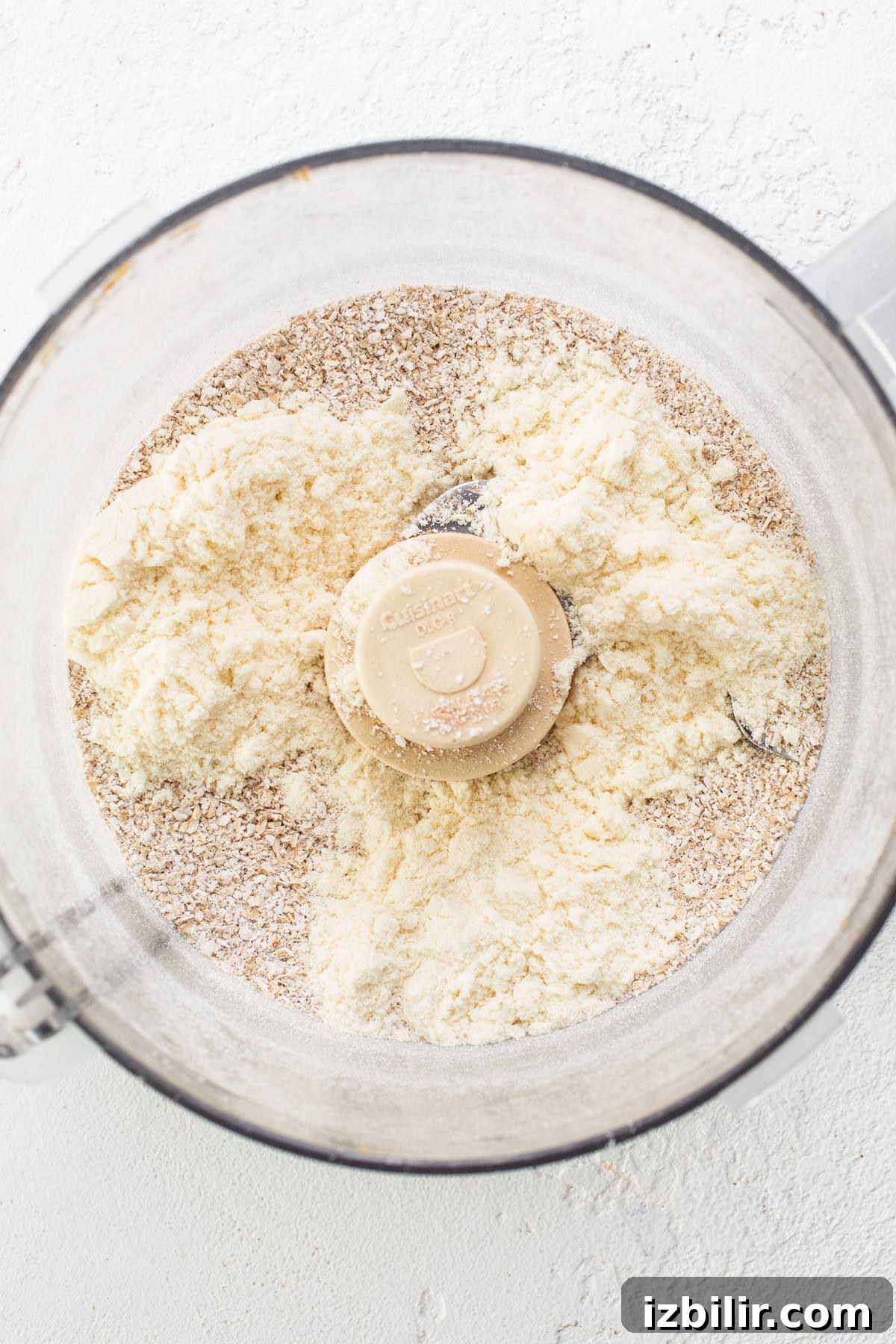 A food processor filled with flour and other ingredients.