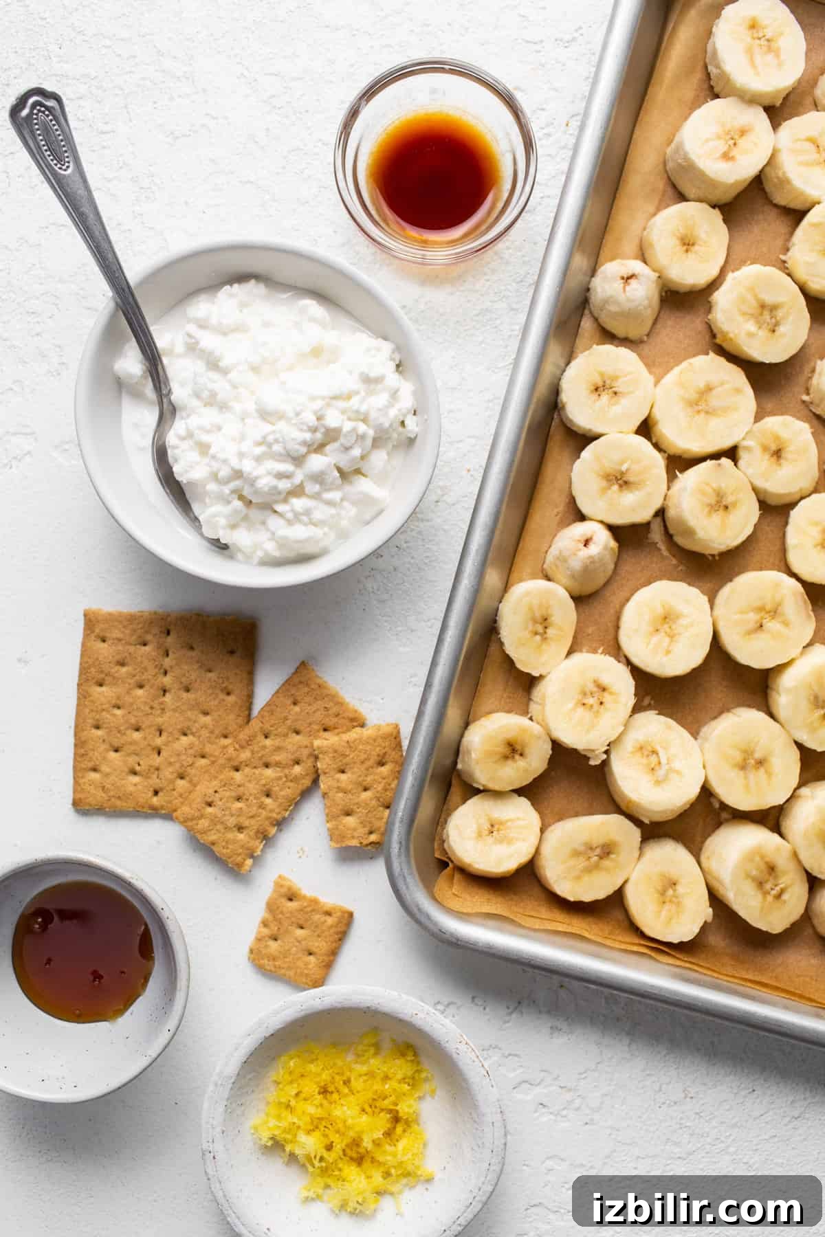 Lemon Cheesecake Nice Cream Recipe 4 Bananas and graham crackers on a tray with a spoon.