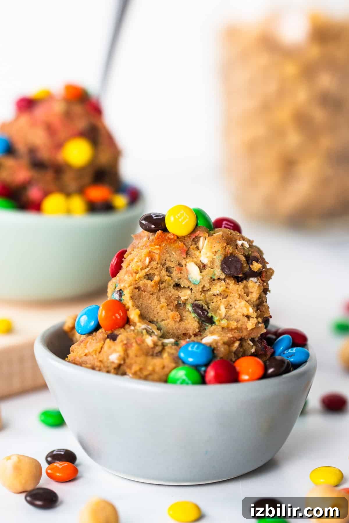 A bowl filled with cookies and m&m's.