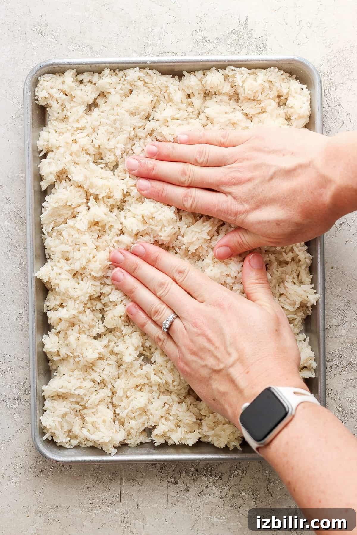 Sheet-Pan Salmon with Crispy Golden Rice 4 Pressing rice into a baking pan