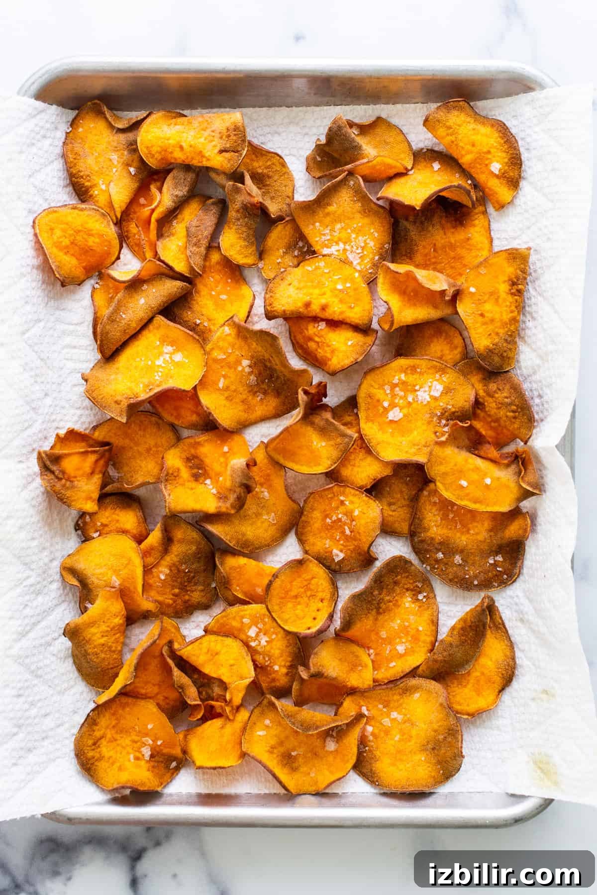 Sweet potato chips on a baking sheet.