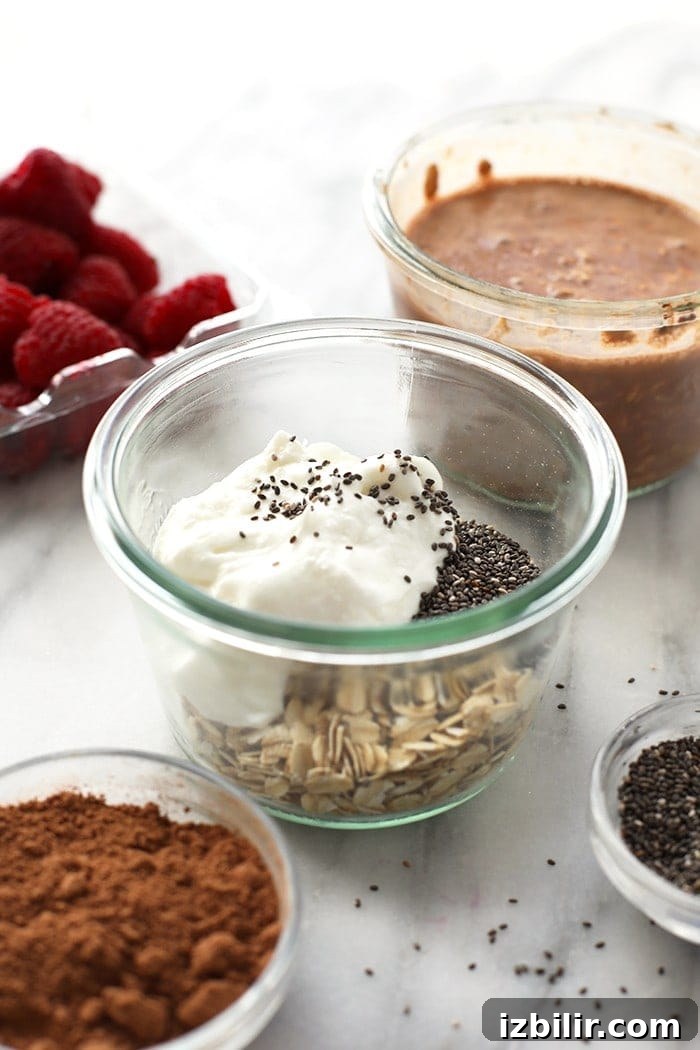 Jars of overnight oats with raspberry swirl and yogurt.