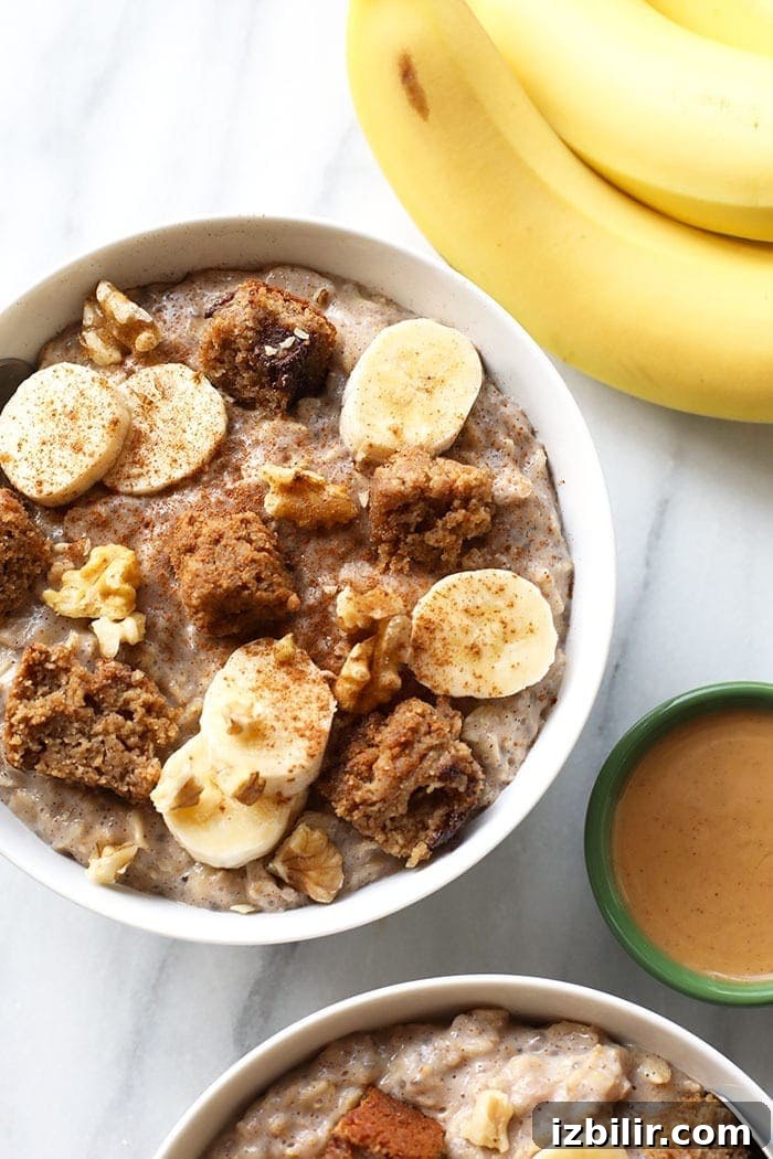 A bowl of banana stovetop oatmeal with sliced banana and cinnamon. bowl of banana oatmeal with bananas and cinnamon