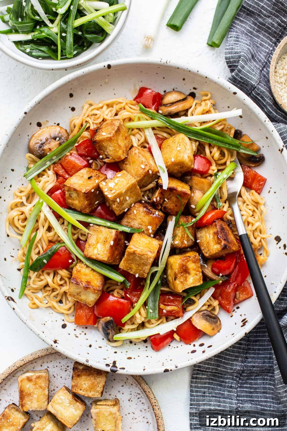 Tofu stir fry on a white plate.