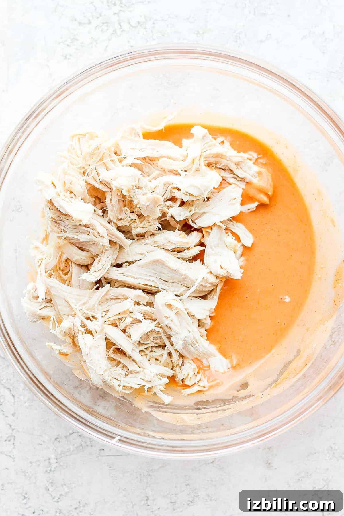 shredded chicken and buffalo sauce in bowl