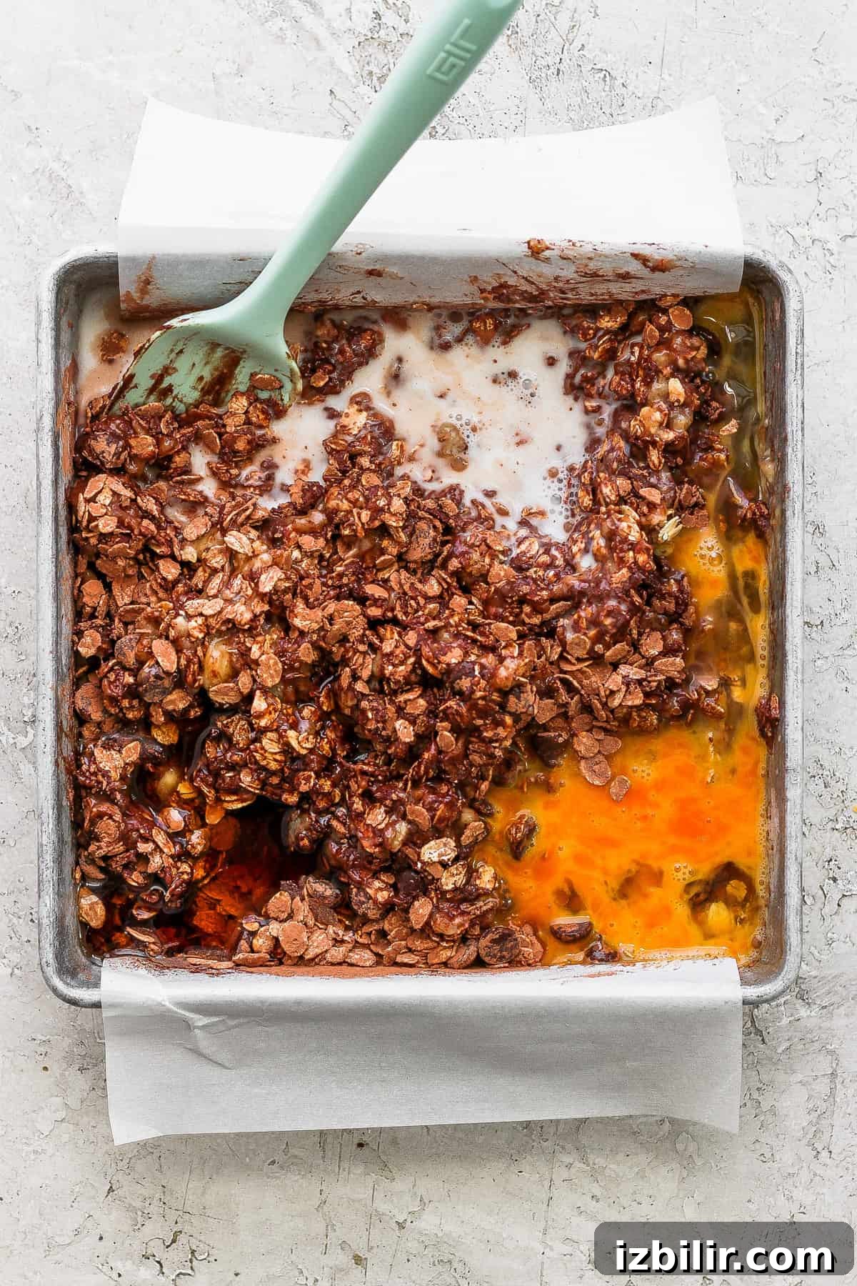 A baking pan with a scoop of granola in it.