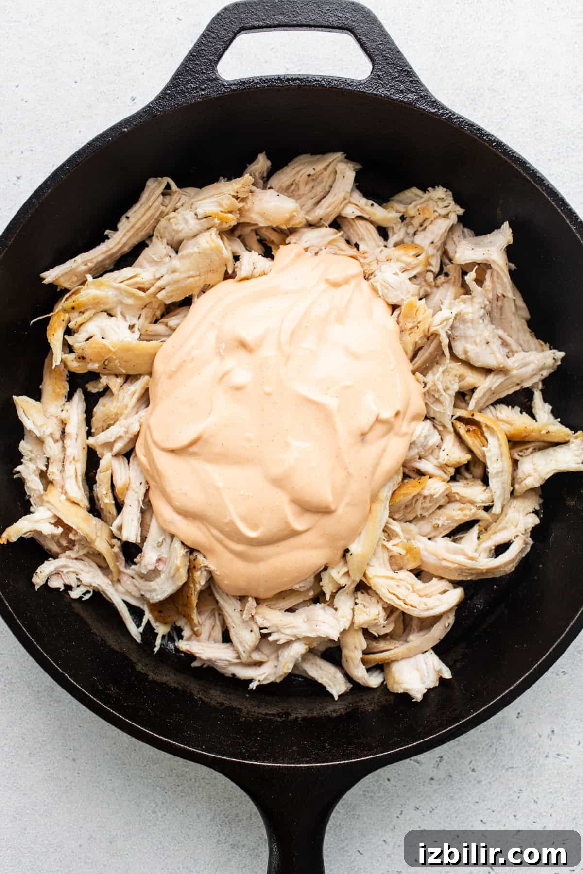 Buffalo Chicken Dip with Whipped Cottage Cheese Recipe 3 Chicken in a skillet with a sauce on top.