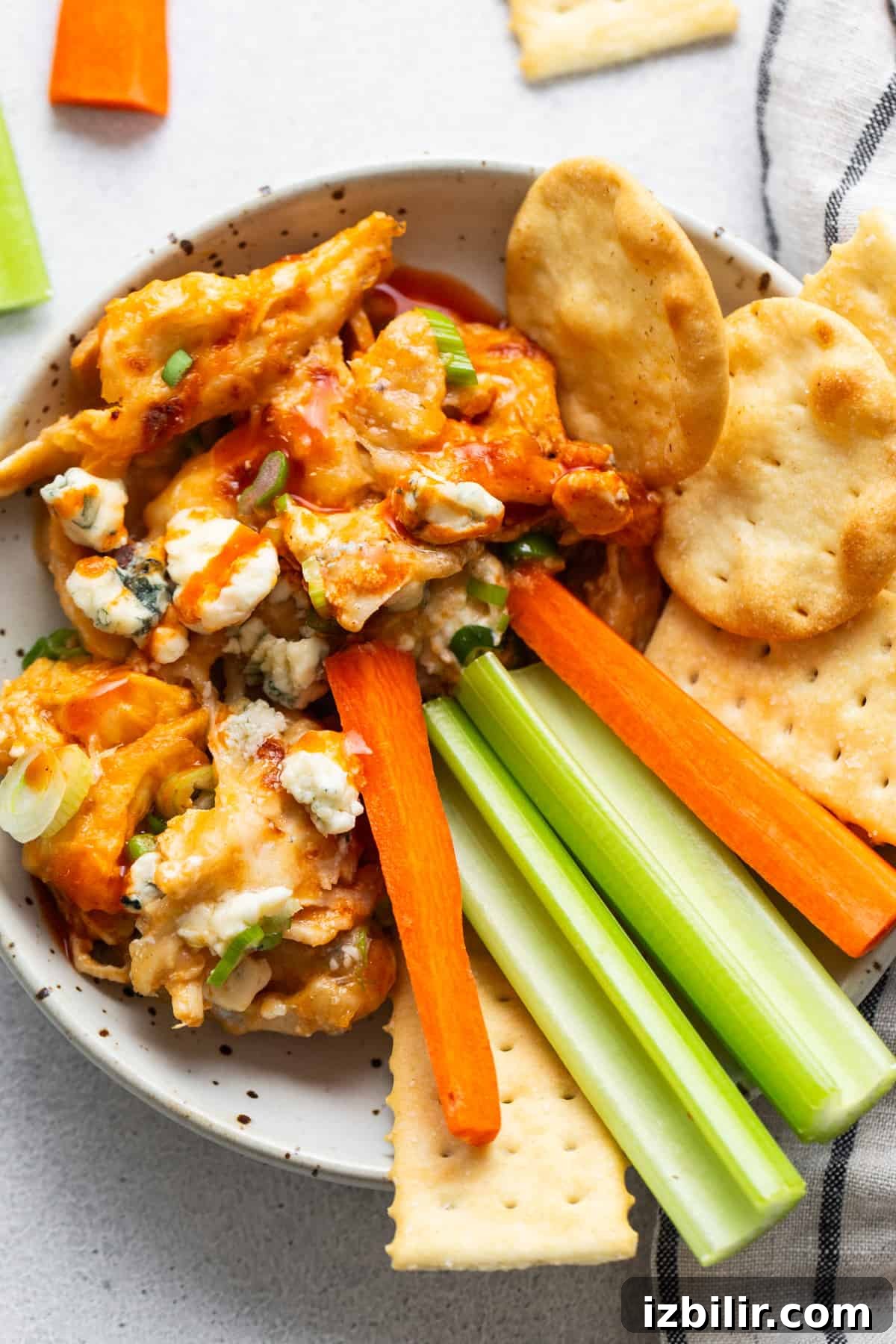 Buffalo Chicken Dip with Whipped Cottage Cheese Recipe 6 Buffalo wings dip in a bowl with celery, carrots and crackers.